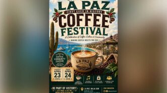 Poster for La Paz Coffee Festival with a large coffee cup, cacti, boats and coastline; dates April 23–24, 2026; tagline 'Where coffee meets the sea'.