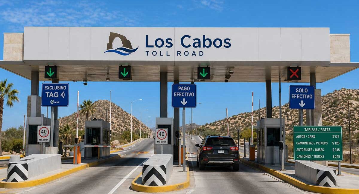 Toll booth lane at Los Cabos Toll Road with green downward arrows and a black SUV approaching the gate, desert hills in the background.