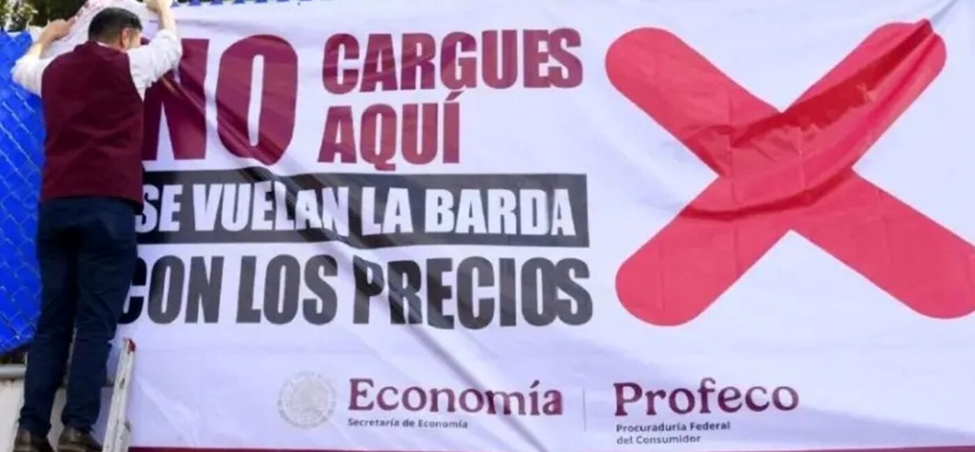 Two men on a ladder hang a large protest banner with a bold red X, calling out high prices; government logos shown at the bottom.