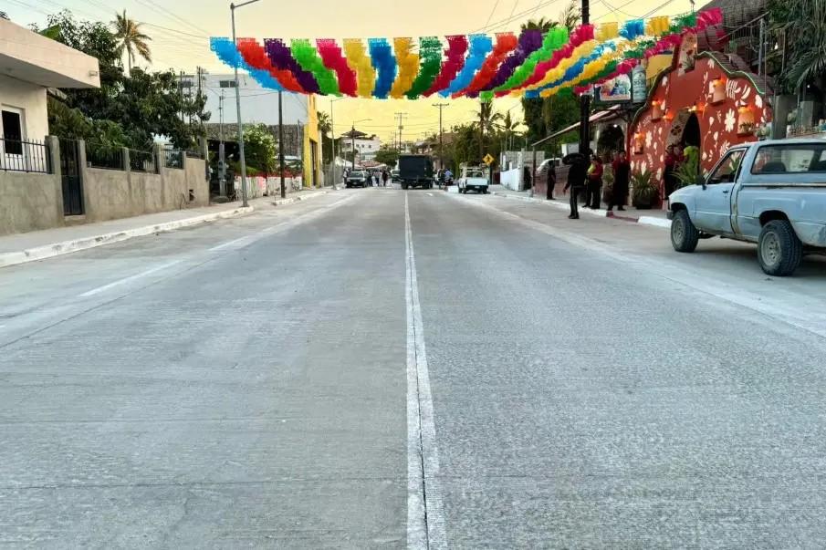 Destinan-recursos-federales-en-Los-Cabos-para-vivienda-parques-y-desarrollo-rural - Gringo Gazette Colorful pennant banners stretched across a quiet urban street during a festival and sunset.