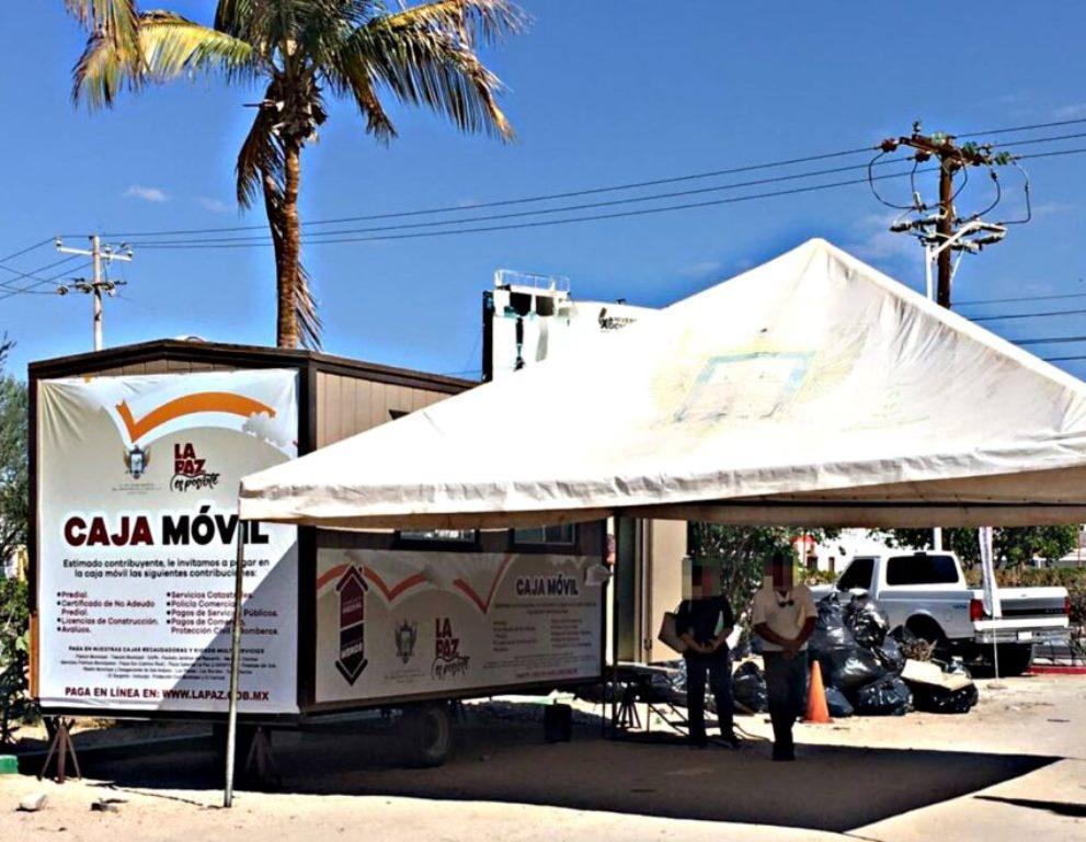 Property-Taxes - Gringo Gazette Mobile bank truck labeled Caja Móvil under a white canopy, with a palm tree and people nearby.