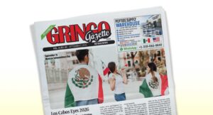 Tilted newspaper front page labeled 'Gringo Gazette' with people wearing Mexican flags at a celebration outside.