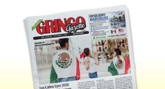Tilted newspaper front page labeled 'Gringo Gazette' with people wearing Mexican flags at a celebration outside.