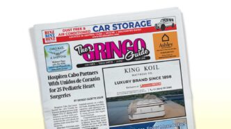 Tilted front page of a newspaper titled The Gringo Guide with a bold pink-and-black masthead, featuring a large headline about pediatric heart surgeries and surrounding ads and images,set against a light background.