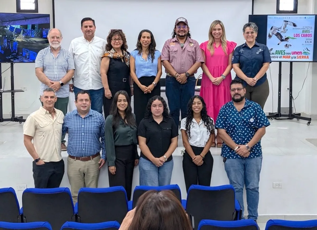 Los Cabos Bird Festival Returns With 2026 Lineup - Gringo Gazette Diverse group of professionals posing for a team photo in a conference room.